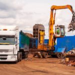 Scrap handler loading sheared steel into a truck