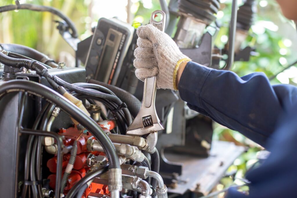 Mechanic repairing hydraulic hoses and fittings