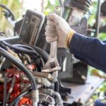 Mechanic repairing hydraulic hoses and fittings